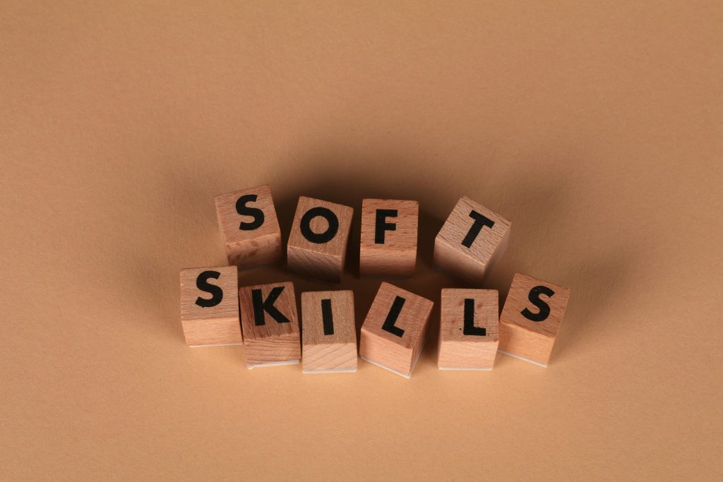 Wooden letter blocks spell out 'Soft Skills', highlighting business and personal development concepts.